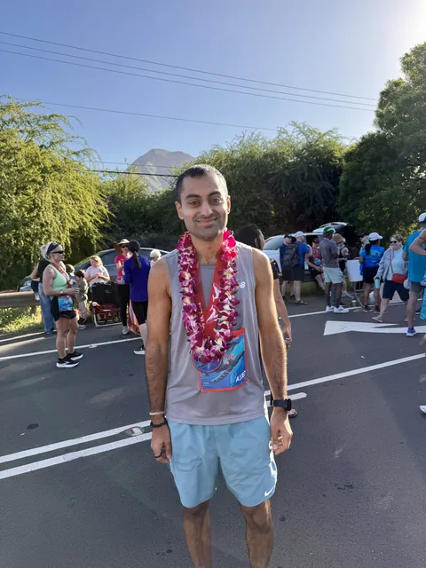 Ritvik wearing a finisher lei at a destination race